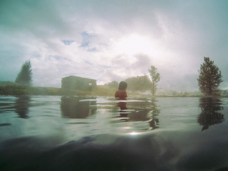 Girl bathing at the secret lagoon in Iceland