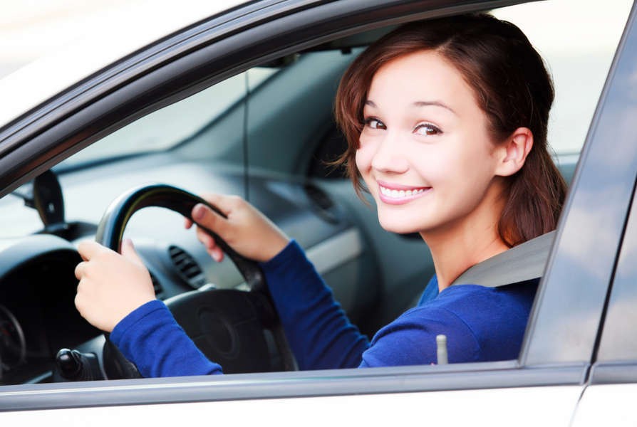 Driving age in Iceland: documents and requisites Young woman driving her rental car