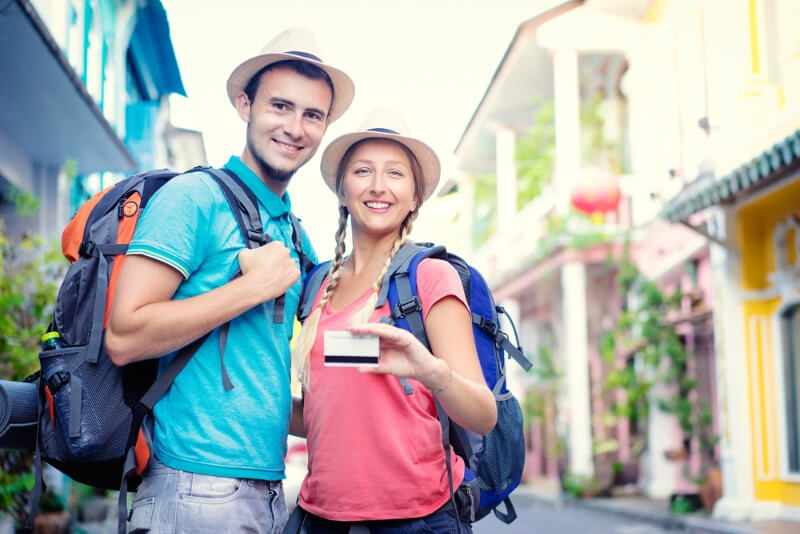 Tourist holding an iceland discount card to save more money