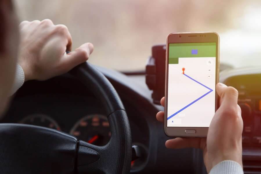 Driver Following GPS Directions on Smartphone – Hands-On Navigation for Road Trips
